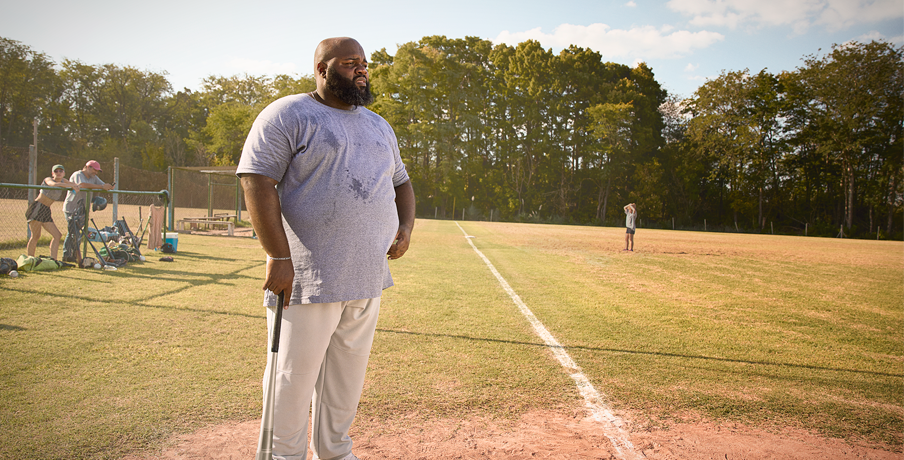 Man standing on baseball field with a bat